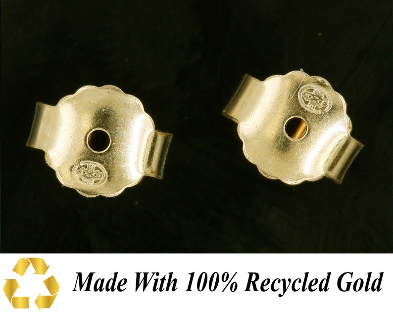 May include: Two gold-toned earring backs with a small hole in the center. The backs are made with 100% recycled gold.