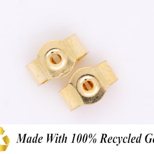 May include: Two gold-colored earring backs, made with 100% recycled gold.  The backs are designed to secure earrings in place.