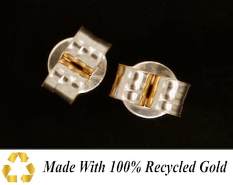 May include: Two silver earring backs with a gold band in the centre. Made with 100% recycled gold.