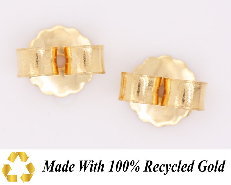 May include: Two gold earring backs made with 100% recycled gold. The backs are designed to fit over the post of an earring.