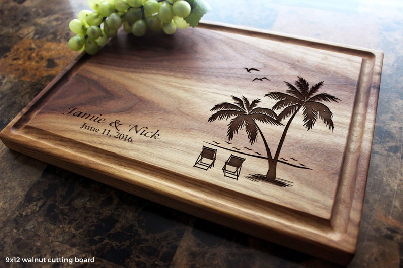 Handmade from natural hardwood personalized cutting board. Never stained, 100% food safe, only finished with food grade mineral oil and beeswax. 12x9 inches Walnut Wooden board with palm trees and beach chairs design number 409.