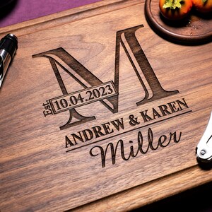 Handmade from natural hardwood personalized cutting board.Never stained, 100% food safe,only finished with food grade mineral oil and beeswax.12x9 inches Walnut Wooden board with central design number 003 with initial,date,first names, and last name.