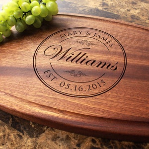 Handmade from natural hardwood personalized cutting board. Never stained, 100% food safe, only finished with food grade mineral oil and beeswax. 12x9 inches Arched Mahogany board with central design number 001 with first names, last name, and date.