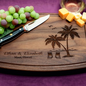 Handmade from natural hardwood personalized cutting board. Never stained, 100% food safe, only finished with food grade mineral oil and beeswax. 12x9 inches Walnut Arched Wooden board with palm trees and beach chairs design number 409.