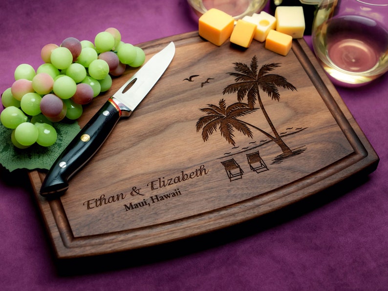 Handmade from natural hardwood personalized cutting board. Never stained, 100% food safe, only finished with food grade mineral oil and beeswax. 12x9 inches Walnut Arched Wooden board with palm trees and beach chairs design number 409.