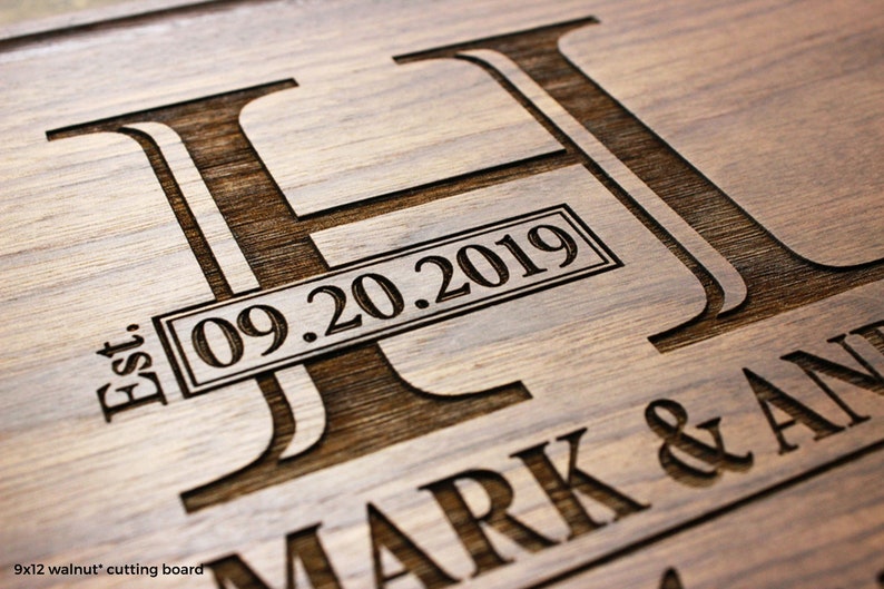 Handmade from natural hardwood personalized cutting board.Never stained,100% food safe,only finished with food grade mineral oil and beeswax. 12x9 inches Walnut Wooden board with central design number 003 with initial, date,first names,and last name.