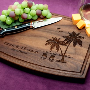 Handmade from natural hardwood personalized cutting board. Never stained, 100% food safe, only finished with food grade mineral oil and beeswax. 12x9 inches Walnut Arched Wooden board with palm trees and beach chairs design number 409.