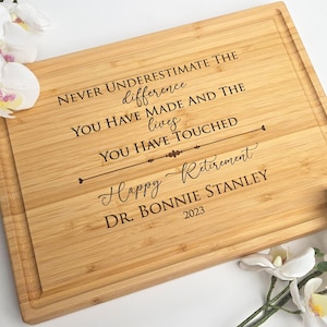 Bamboo cutting board engraved with retirement design. Perfect corporate gift for colleagues .