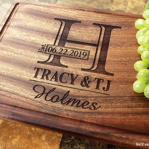 Handmade from natural hardwood personalized cutting board. Never stained, 100% food safe, only finished with food grade mineral oil and beeswax. 12x9 inches Mahogany Wood with central design number 003 with initial, date, first names, and last name.