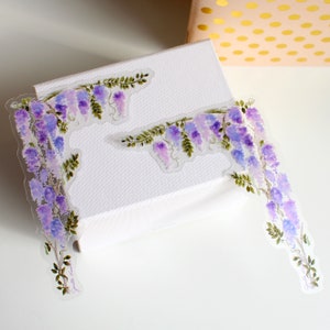 Pegatinas de esquina de glicina (juego de 2) de vinilo transparente con diseño floral de acuarela y flores moradas.