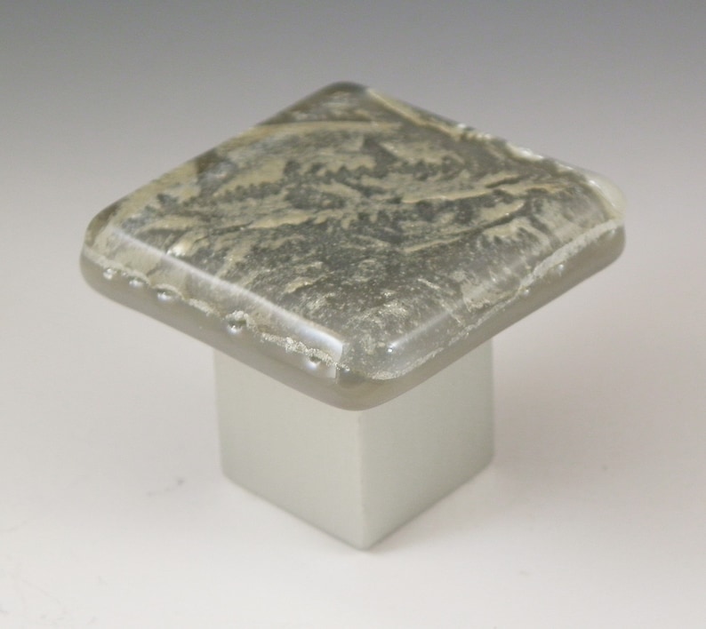 May include: Square glass cabinet knob with a gray and white marbled design. The knob is mounted on a square base.