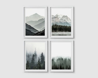 May include: Set of four framed prints featuring black and white photographs of mountain ranges and forests. The prints are in white frames and are arranged in a grid pattern.