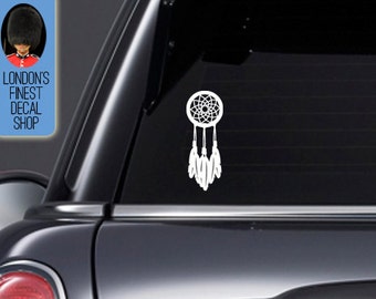 May include: White dreamcatcher decal applied to a car window. The dreamcatcher design features a circular web with hanging feathers. A blue rectangle in the upper left corner displays the text "LONDON'S FINEST DECAL SHOP" with an illustration of a British guard.