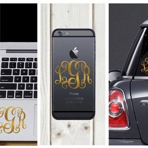 Könnte beinhalten: Goldene Monogramm-Aufkleber mit den Buchstaben LGR auf einem Laptop, Telefon und Autofenster. Das Telefon ist schwarz, das Auto dunkelgrau und der Laptop weiß.