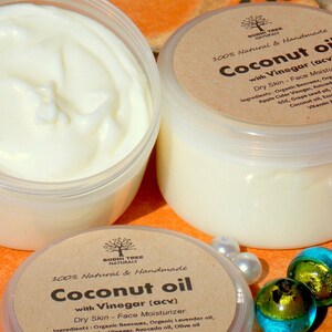 May include: Two glass jars of coconut oil with vinegar face moisturizer. The jars are labeled "100% Natural & Handmade Coconut oil with Vinegar (acv) Dry Skin - Face Moisturizer". The ingredients are listed on the label.
