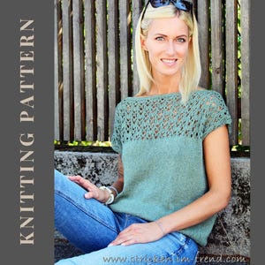 May include: A woman in a green knitted top with a lace yoke and short sleeves, and blue jeans. The top has a solid knit lower section. The text "KNITTING PATTERN" is on the left side of the image.