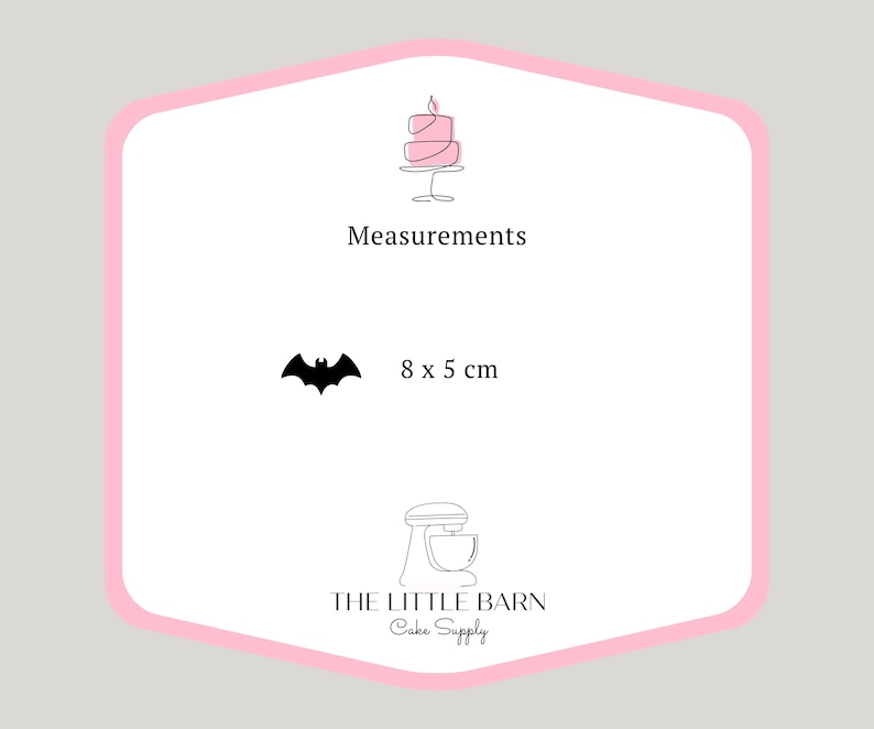 May include: Pink and white cake topper shaped like a bat, measuring 8 by 5 centimeters. The topper is made by The Little Barn Cake Supply.