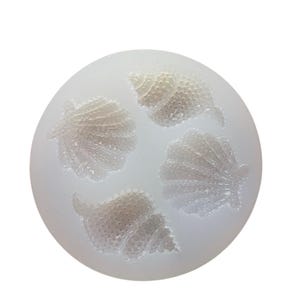 May include: A white silicone mould with four detailed seashell designs. The mould is perfect for making chocolate, candy, or soap.