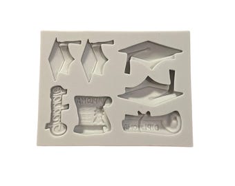 May include: White silicone mold with various graduation themed designs. The mold includes a graduation cap, diploma, and the word "Congratulations".