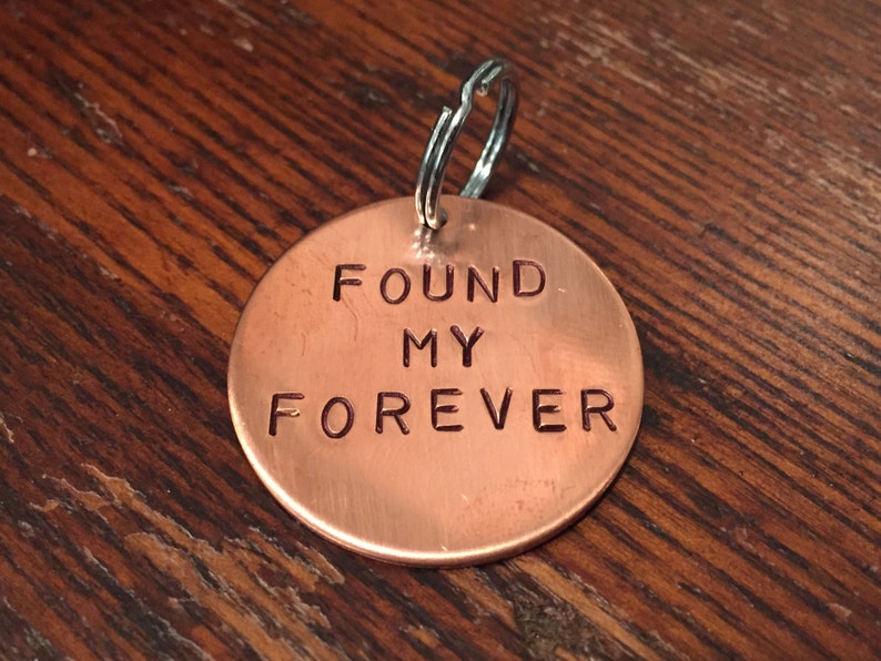 May include: A copper keychain with the words "FOUND MY FOREVER" engraved on it.