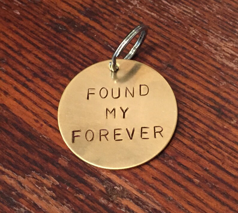 May include: A gold-colored metal keychain with the words "FOUND MY FOREVER" engraved on it.
