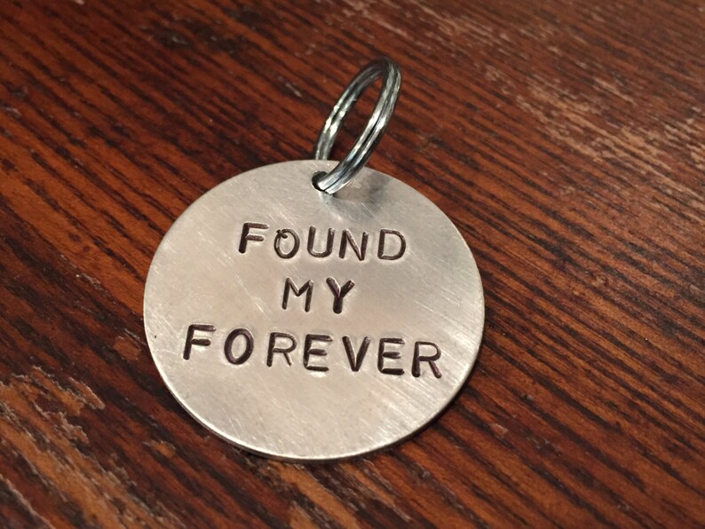 May include: Silver keychain with a round tag that says "FOUND MY FOREVER".