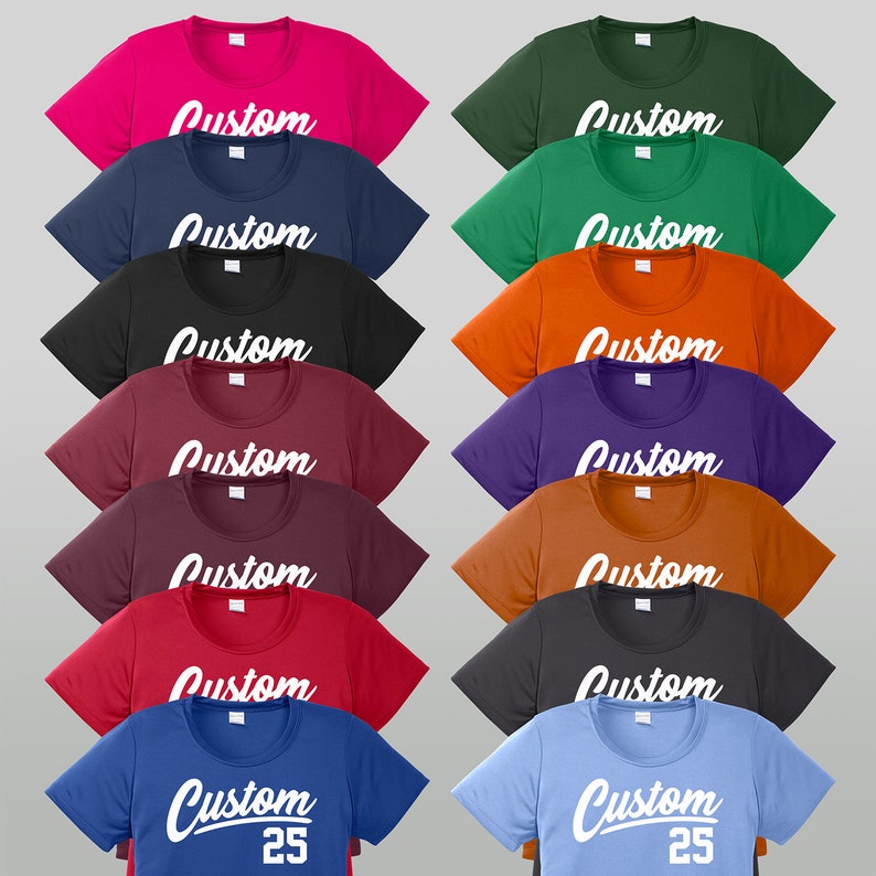 May include: A collection of 14 t-shirts in various colors, each featuring the word "Custom" in white script. Two of the shirts also have the number "25" printed below the word "Custom".