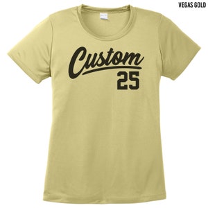 May include: A light yellow t-shirt with a black "Custom" graphic and the number "25" printed on the front. The shirt is made of a lightweight, breathable fabric.