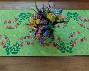 Quilted Table Runner of Bleeding Heart on spring green . Table runner is 50"L x 15"W.  Perfect summer table decor. Great gift, housewarming