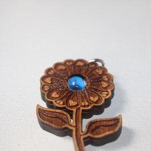 Beautiful Natural Blue Sapphire in a Love Me, Love Me Not Flower Made of Cherry Wood