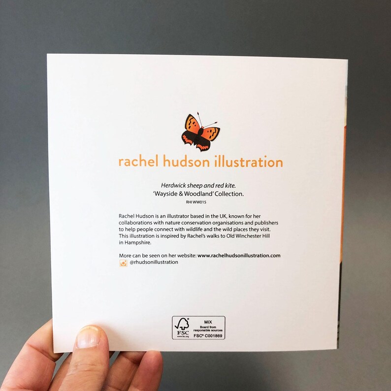 May include: A white card with a brown butterfly illustration and text that reads "rachel hudson illustration" and "Herdwick sheep and red kite. 'Wayside & Woodland' Collection. RHI WW015". The card also includes a small, green FSC logo with the text "MIX Board from responsible sources FSC C001809".