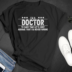 National Hospitalist Day Doctor Save Time Assume Never Wrong Humor Premium Short Sleeve Unisex T-shirt Tee Shirt Small - 3XL Free Shipping