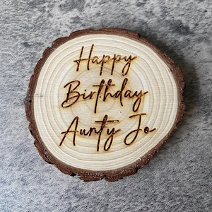 May include: A wooden slice with the text "Happy Birthday Aunty Jo" engraved on it.