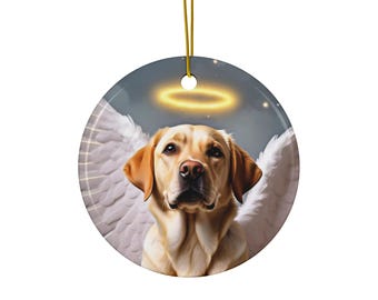 May include: A round ceramic ornament featuring a golden Labrador Retriever with white angel wings and a golden halo. The dog has a soft, light brown coat and is centered against a background of a starry night sky. A gold string is attached for hanging.