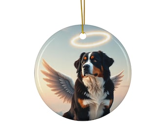 May include: Circular ceramic ornament depicting a Bernese Mountain Dog with angel wings and a halo. The dog has black, brown, and white fur. The background is a soft, pastel sky. A gold string is attached for hanging.