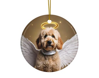 May include: A ceramic ornament featuring a golden doodle dog with white angel wings and a halo. The dog is looking directly at the viewer with a sweet expression.