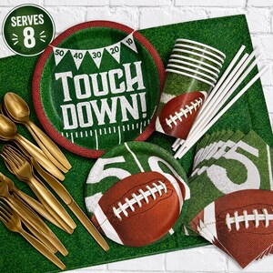 May include: A football-themed party supply set featuring green plates with the text TOUCH DOWN, cups with football graphics, white paper straws, gold-toned plastic forks, and napkins with football imagery. A circular badge indicates it serves 8.