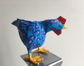 Small blue and pink sculpted paper Easter hen.