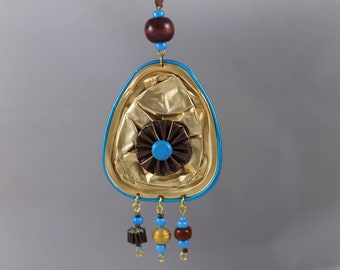 Necklace with a large turquoise gold pendant.