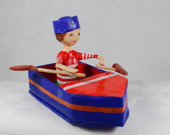 Decoration for children, the little sailor in his boat. Paper mache sculpture.