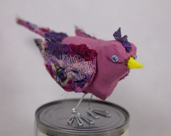 Small bird in pink and purple fabric. Unique decoration.