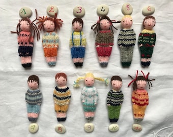 Small hand knitted dolls in wool, traditional toy. For children.