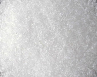 May include: A close-up view of a pile of white salt crystals.