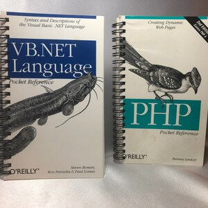 May include: Two spiral bound pocket reference books, one for VB.NET Language and the other for PHP. The VB.NET book features a black and white illustration of a catfish. The PHP book features a black and white illustration of a bird.