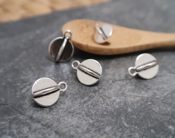 May include: Five silver-toned metal charms in the shape of a circle with a raised line down the center. The charms have a loop at the top for attaching to jewelry or other crafts.