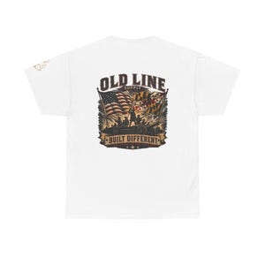 May include: A white short-sleeve t-shirt featuring a graphic on the back. The design displays the text OLD LINE SUPPLY and BUILT DIFFERENT with an illustration of soldiers, a cannon, the American flag, and the Maryland state flag.