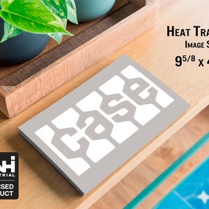 May include: A gray heat transfer with the word "CASE" in a white, stylized font. The image size is 9 5/8 x 4 7/8 inches. The CNH Industrial licensed product logo is in the lower left corner. The transfer is on a wooden surface.