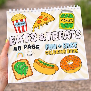 May include: A spiral-bound coloring book titled "EATS & TREATS" with illustrations of food items like popcorn, pizza, pickles, avocado toast, a hot dog, and a donut. The cover also includes the text "48 PAGE FUN + EASY COLORING BOOK".