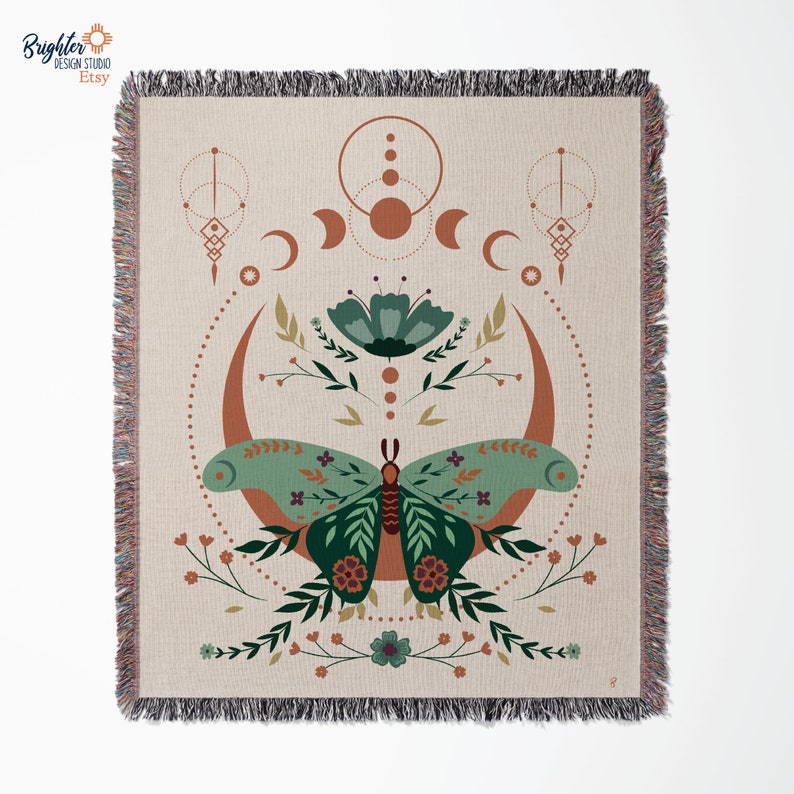 May include: A woven tapestry featuring a green butterfly with floral accents, surrounded by a crescent moon and geometric shapes in shades of brown and orange.
