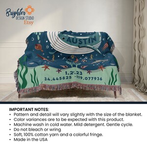 May include: A blue and green woven throw blanket with a whale design and the name "AUSTIN" in white text. The blanket also features a starfish, seashells, and the coordinates "34.445825 -119.077936" and the date "1.21.23".